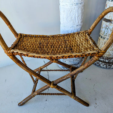 Cane stool with braided straps and palm wood stretchers