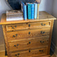 Pine chest of drawers with flutted side pilasters.