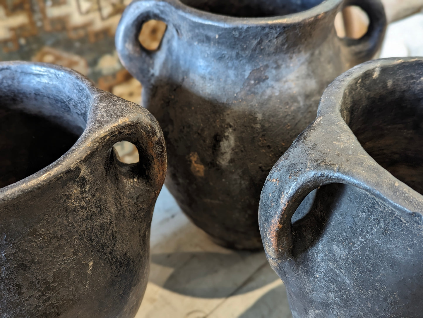 Set of three blacken ceramic pots