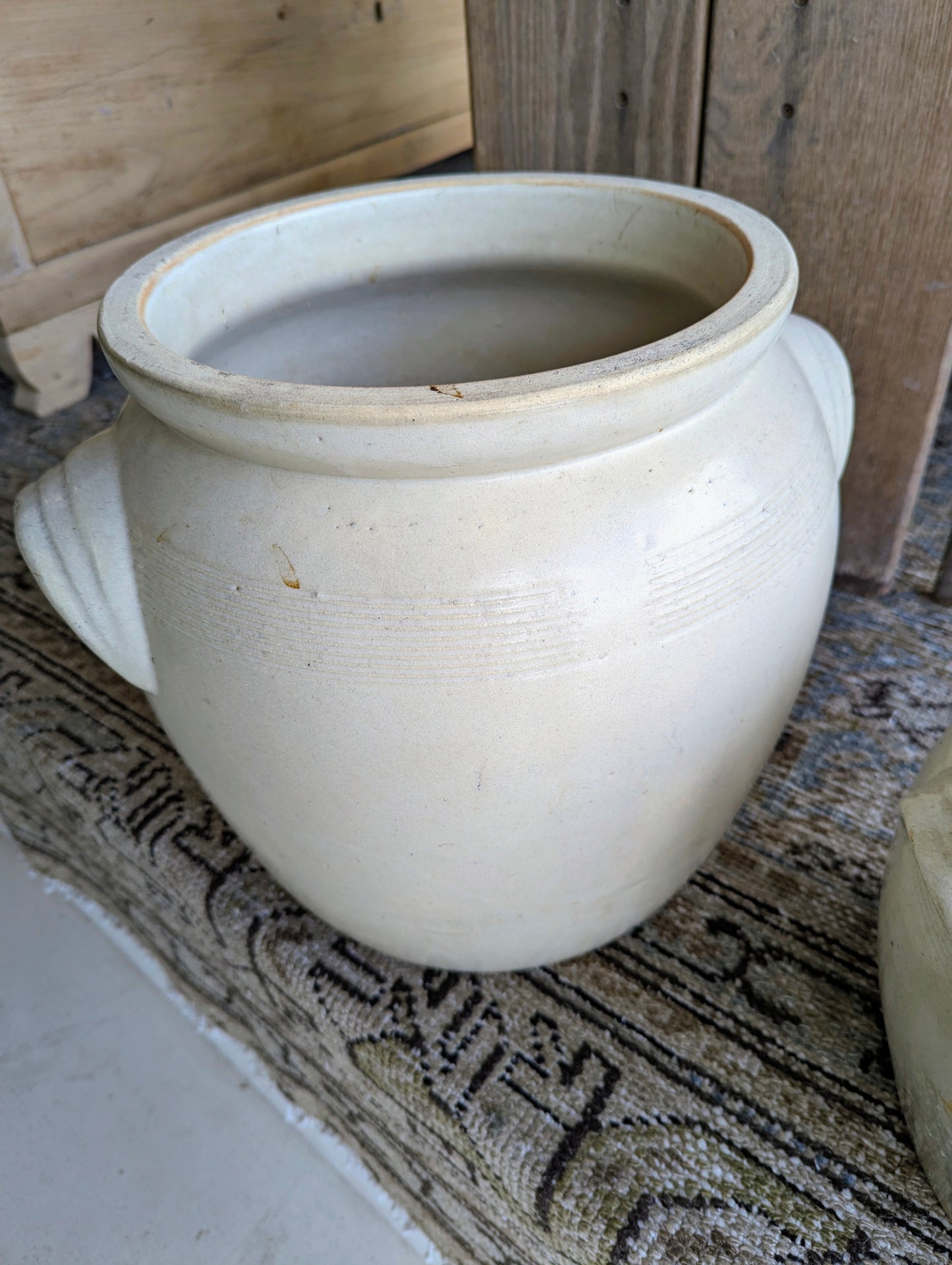 Two creamy coloured ceramic pots.