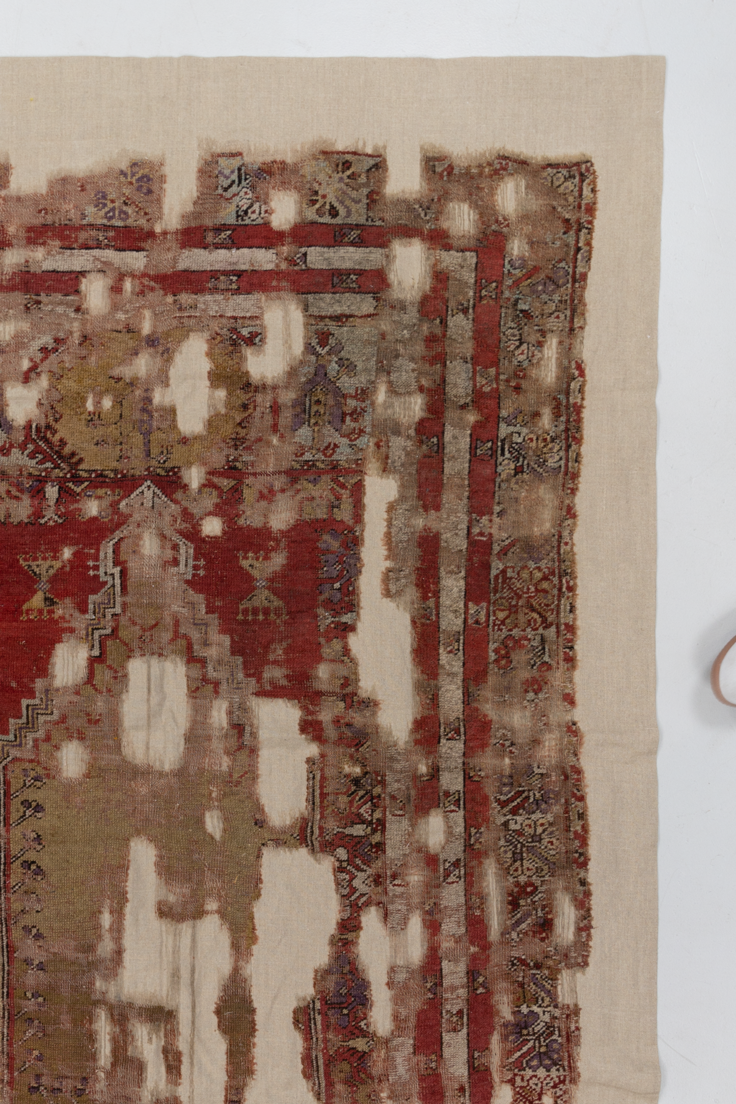Antique Anatolian Rug Fragment on Linen